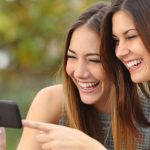 Frauen schauen Video auf Smartphone an