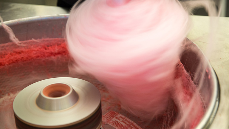 zuckerwattemaschine-bedienen-und-reinigen-Soklappt’s-2 Rosafarbene Zuckerwatte wird in einer Zuckerwattemaschine aufgewickelt