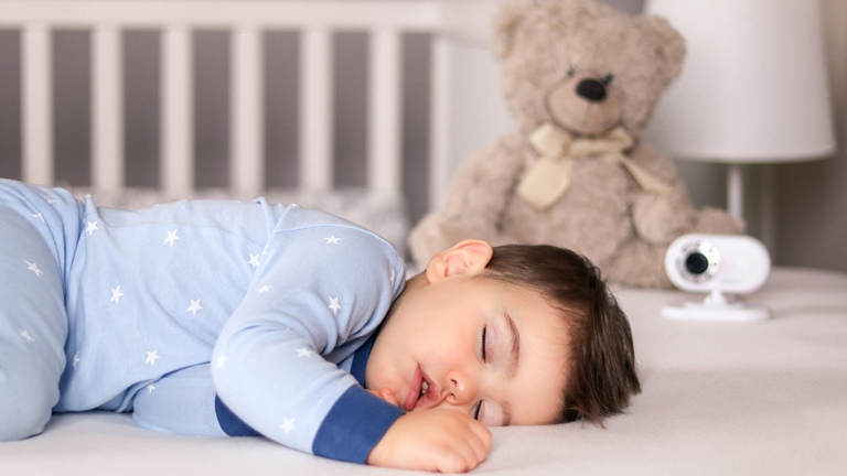 Kind schl&auml;ft neben Video-Babyphone