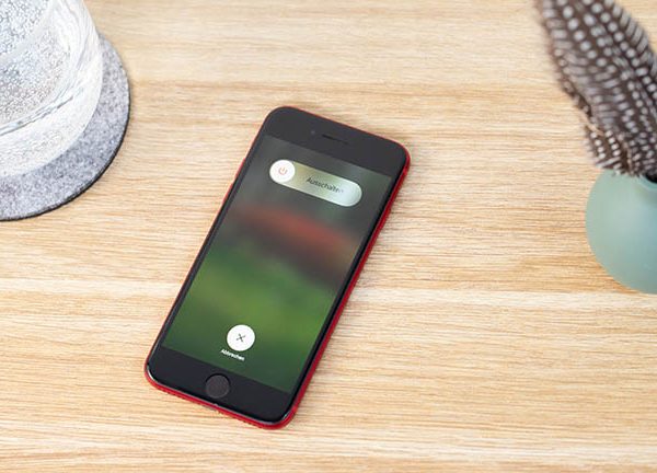 Das iPhone SE liegt auf einem Tisch. Auf dem Display ist der Bildschirm zum Ausschalten des Ger&auml;ts zu sehen.