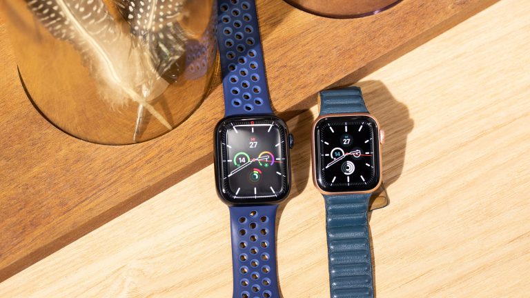 Eine Apple Watch 7 und eine Apple Watch SE liegen nebeneinander auf dem Tisch.