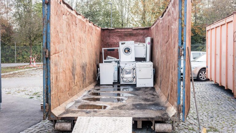 Blick in einen Container auf einem Wertstoffhof. Darin sind einige Waschmaschinen zu sehen.