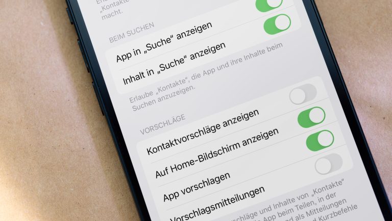 Nahaufnahme eines iPhones, auf dessen Bildschirm die Siri-Einstellungen zu sehen sind.