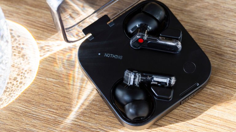 Die Nothing Ear (3) mit ge&ouml;ffnetem Case auf einem Tisch.