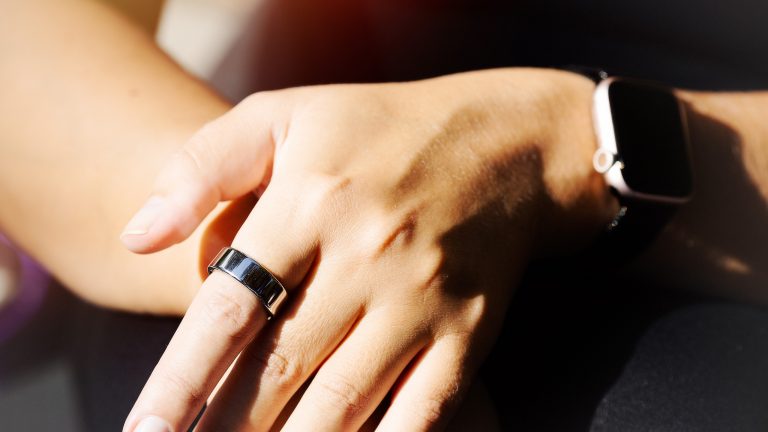 Detailaufnahme einer linken Hand an der ein Smart Ring am Zeigefinger getragen wird.