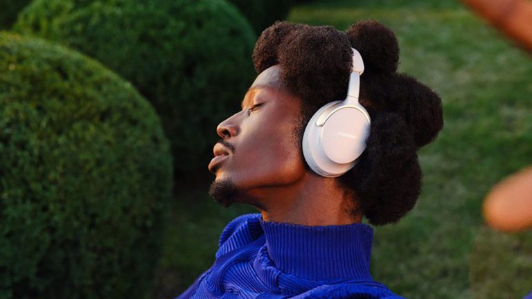 Seitenansicht einer Person, die mit geschlossenen Augen Musik h&ouml;rt und die Bose QuietComfort Ultra Over-Ear-Kopfh&ouml;rer tr&auml;gt.