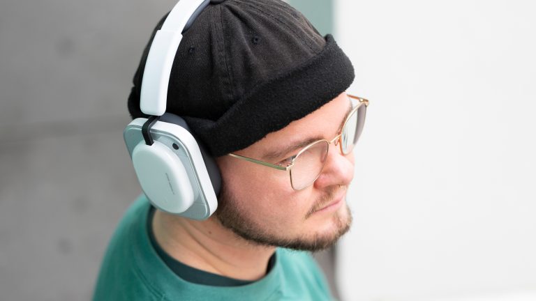 Eine Person tr&auml;gt die Nothing Headphone (a) &uuml;ber einer M&uuml;tze.