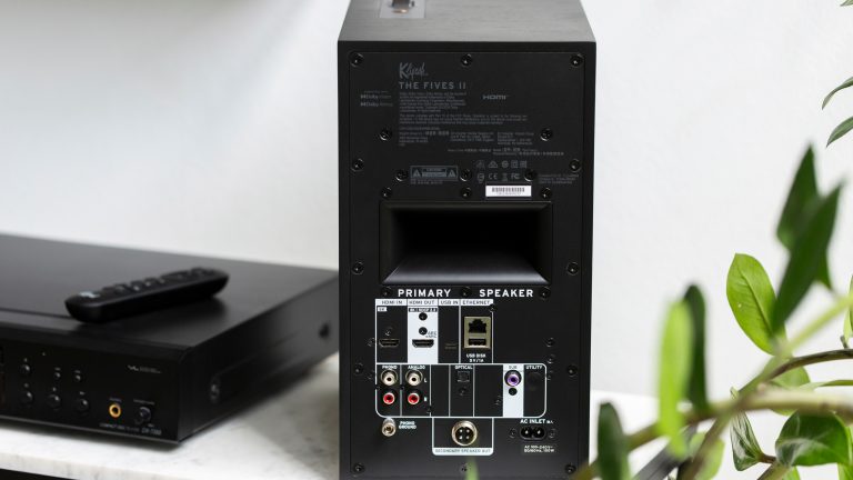Klipsch The Fives II, Lautsprecher mit sattem Sound im Praxistest Blick auf die Rückseite der Aktiv-Box von einem Klipsch The Fives II, der neben einem CD-Player steht.