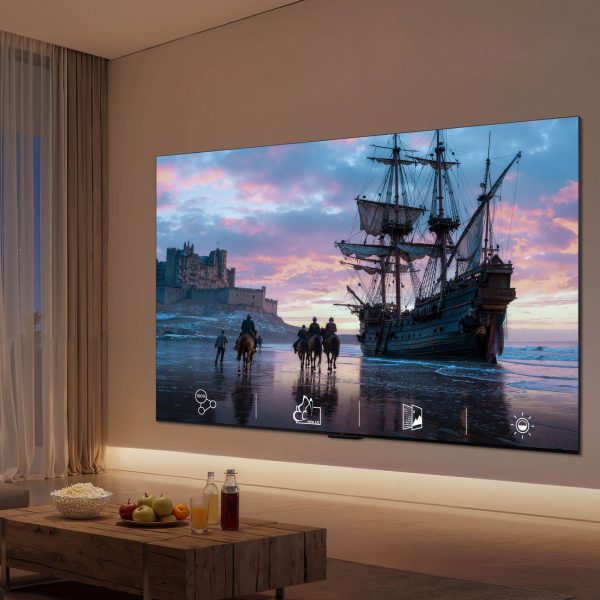 In einem Wohnzimmer ist ein Fernseher an der Wand montiert, auf dem Bildschirm ist ein altes Segelschiff zu sehen.