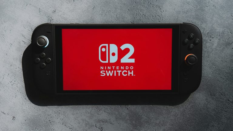 Eine Nintendo Switch 2 liegt auf einer Stein-Oberfläche, auf den Screen ist das Logo der Konsole zu sehen.